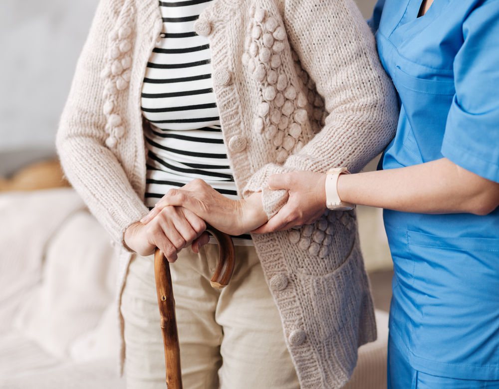 A nurse caring for a patient at home